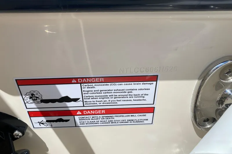  Yacht Photos Pics Warning labels on 2026 Grady-White Canyon 306 boat, highlighting carbon monoxide and propeller dangers.