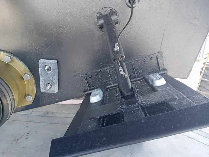 Oxygen III Yacht Photos Pics Close-up of a 2007 Pershing 56 boat component, featuring a hydraulic trim tab.