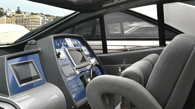 Oxygen III Yacht Photos Pics Cockpit of a 2007 Pershing 56 yacht with modern navigation equipment and plush seating.