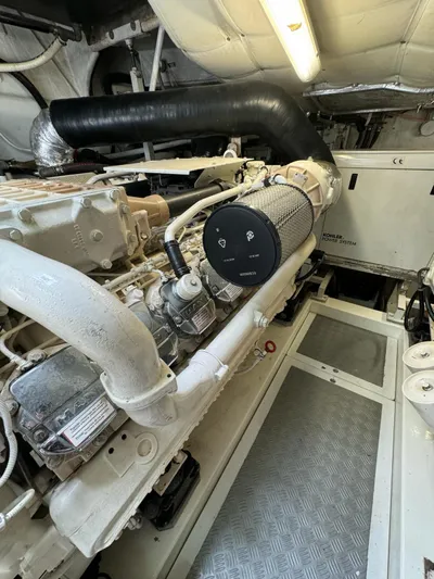 Oxygen III Yacht Photos Pics Engine room of a 2007 Pershing 56 yacht, showcasing mechanical components and piping.