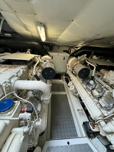 Oxygen III Yacht Photos Pics Engine room of a 2007 Pershing 56 yacht, showcasing dual engines and mechanical components.