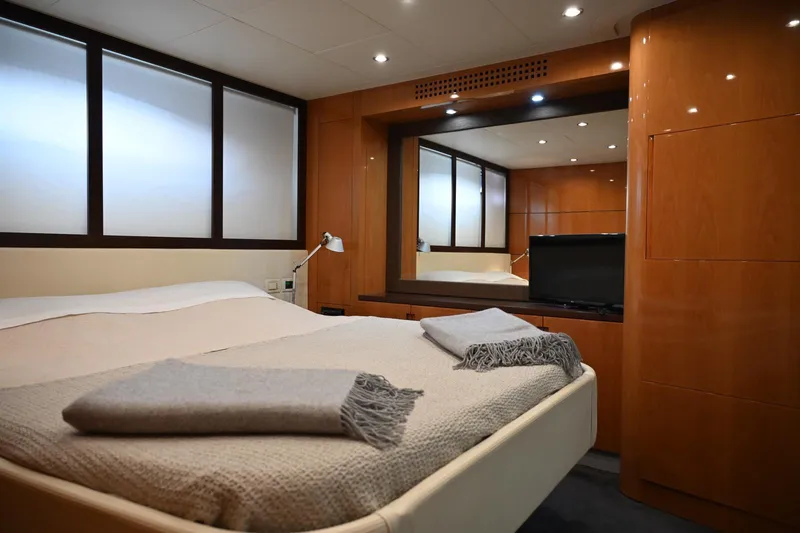 Oxygen III Yacht Photos Pics Luxurious bedroom interior of 2007 Pershing 56 yacht with modern wood paneling.