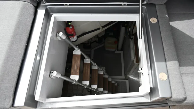 Oxygen III Yacht Photos Pics Hatch entrance with stairs on a 2007 Pershing 56 yacht, featuring a fire extinguisher.