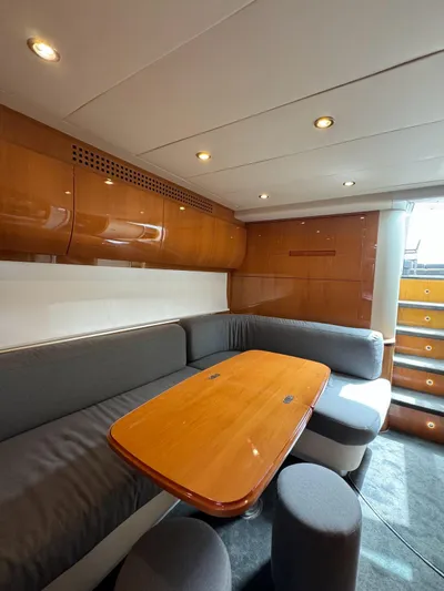 Oxygen III Yacht Photos Pics Luxurious interior of a 2007 Pershing 56 yacht with elegant wood finishes and cozy seating.