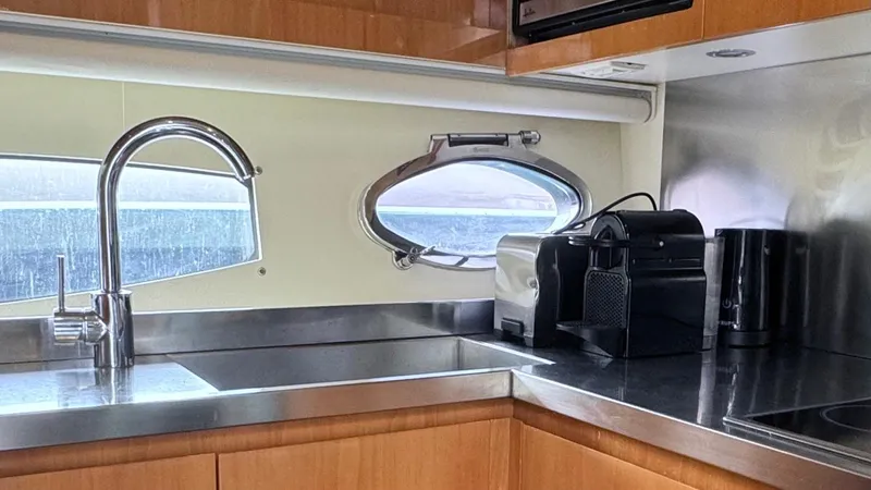 Oxygen III Yacht Photos Pics Modern kitchen interior of 2007 Pershing 56 yacht with stainless steel appliances.