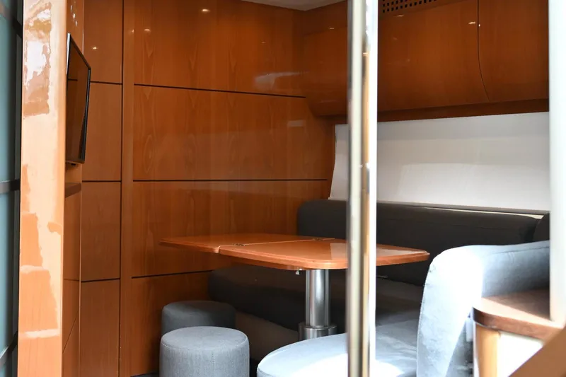 Oxygen III Yacht Photos Pics Luxurious interior of a 2007 Pershing 56 yacht with sleek wood paneling and modern seating.