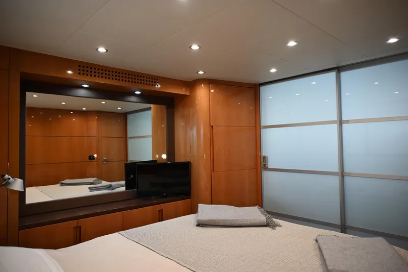 Oxygen III Yacht Photos Pics Luxurious cabin interior of 2007 Pershing 56 yacht with modern wood paneling and ambient lighting.