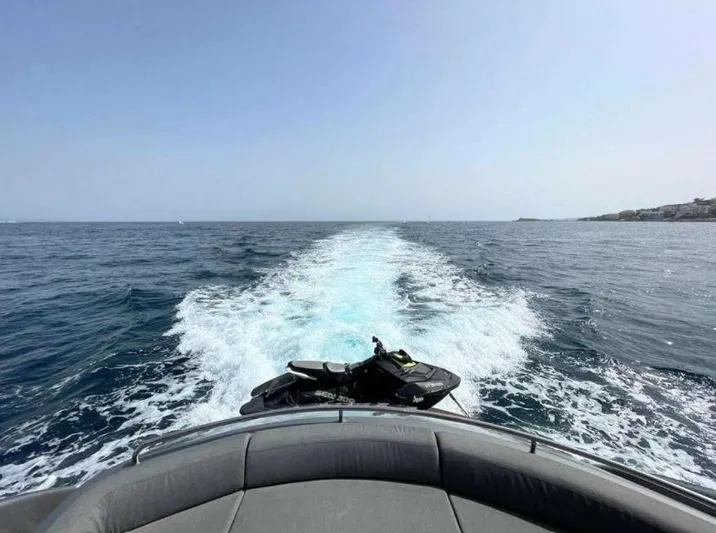 Oxygen III Yacht Photos Pics 2007 Pershing 56 yacht cruising on open sea with jet ski on deck.