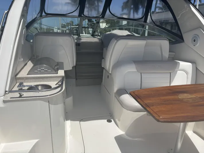 Mocaccino Yacht Photos Pics 2011 Sea Ray 350 Sundancer interior with seating, table, and kitchenette.