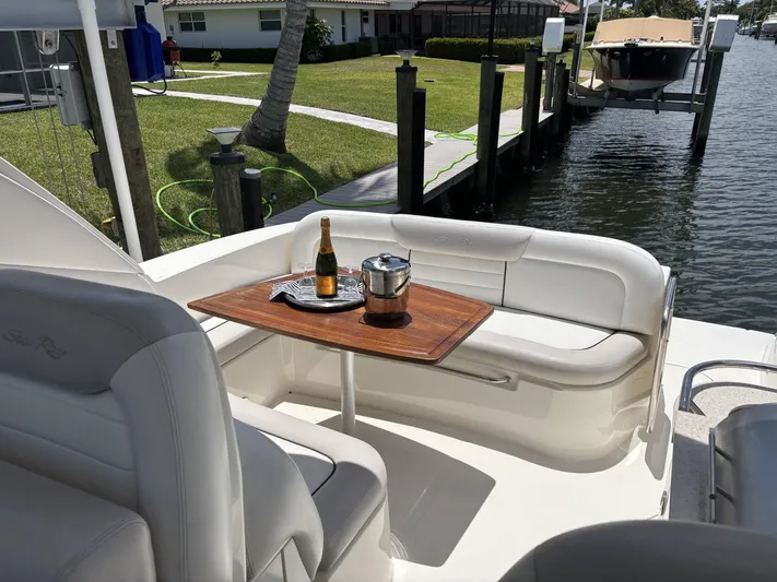 Mocaccino Yacht Photos Pics 2011 Sea Ray 350 Sundancer yacht interior with champagne on table by the dock.