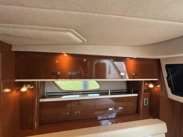 Mocaccino Yacht Photos Pics Interior of 2011 Sea Ray 350 Sundancer yacht with wooden cabinets and ambient lighting.