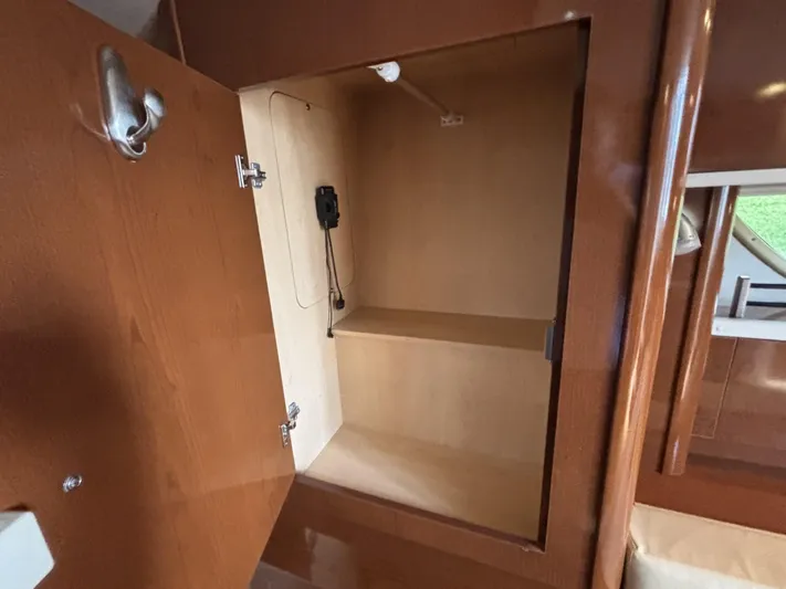 Mocaccino Yacht Photos Pics Open storage compartment inside 2011 Sea Ray 350 Sundancer boat, featuring wooden interior.