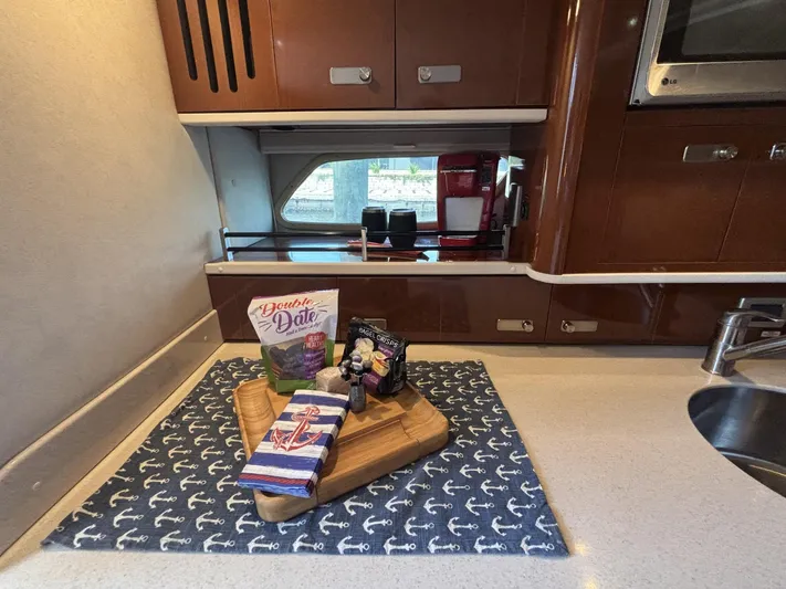 Mocaccino Yacht Photos Pics Kitchen area of 2011 Sea Ray 350 Sundancer with snacks on a cutting board.