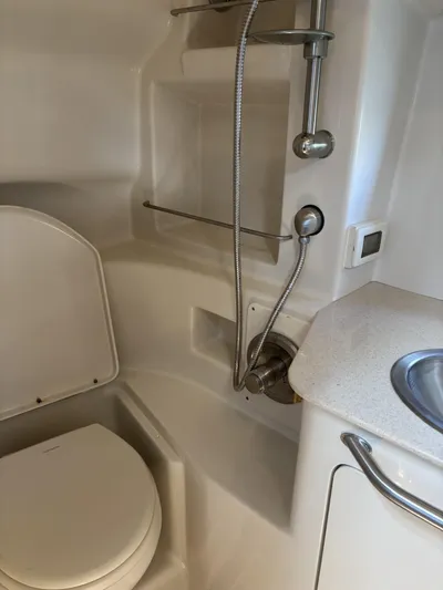 Mocaccino Yacht Photos Pics 2011 Sea Ray 350 Sundancer bathroom with shower, toilet, and sink.