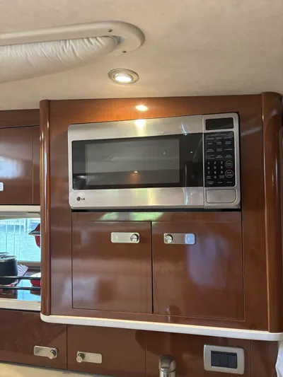 Mocaccino Yacht Photos Pics Microwave in 2011 Sea Ray 350 Sundancer yacht kitchen with wooden cabinetry.