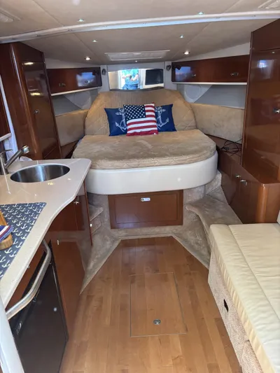 Mocaccino Yacht Photos Pics 2011 Sea Ray 350 Sundancer interior with bed, kitchenette, and American flag pillows.