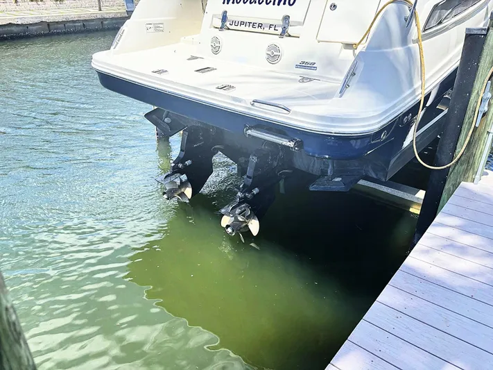 Mocaccino Yacht Photos Pics 2011 Sea Ray 350 Sundancer docked, showing stern and propellers in water.