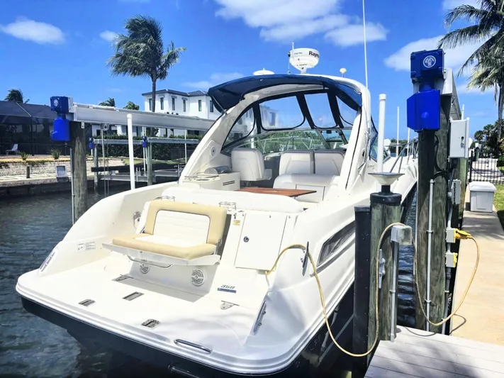 Mocaccino Yacht Photos Pics 2011 Sea Ray 350 Sundancer docked, showcasing sleek design and spacious deck under clear skies.