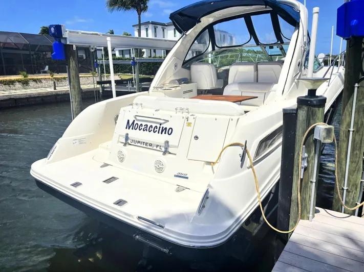 Mocaccino Yacht Photos Pics 2011 Sea Ray 350 Sundancer docked, rear view, named "Mocaccino," in sunny marina setting.
