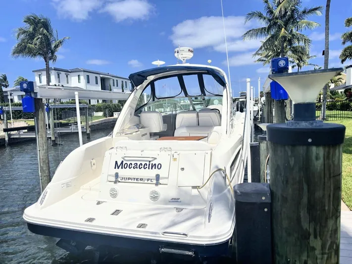 Mocaccino Yacht Photos Pics 2011 Sea Ray 350 Sundancer docked, sunny day, palm trees, waterfront property.