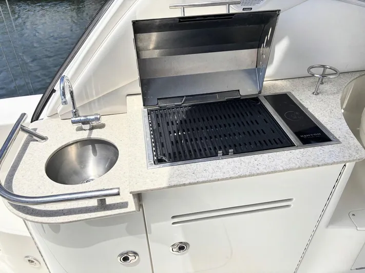 Mocaccino Yacht Photos Pics Outdoor kitchenette on 2011 Sea Ray 350 Sundancer with sink and grill.