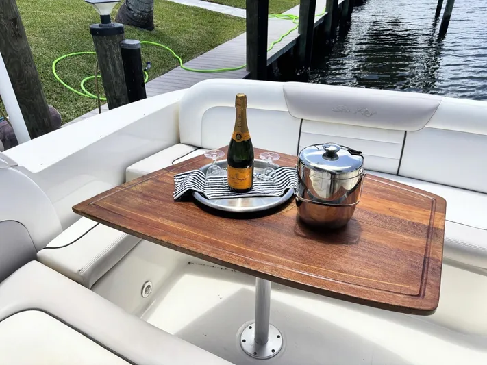 Mocaccino Yacht Photos Pics Luxury Sea Ray 350 Sundancer 2011 with champagne setup on wooden table.