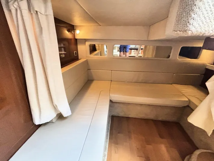 Mocaccino Yacht Photos Pics Interior cabin of 2011 Sea Ray 350 Sundancer yacht with beige seating and wood accents.