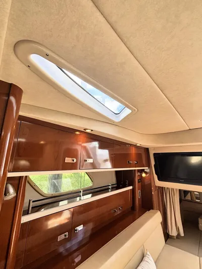 Mocaccino Yacht Photos Pics Interior of 2011 Sea Ray 350 Sundancer yacht with skylight and wooden cabinetry.