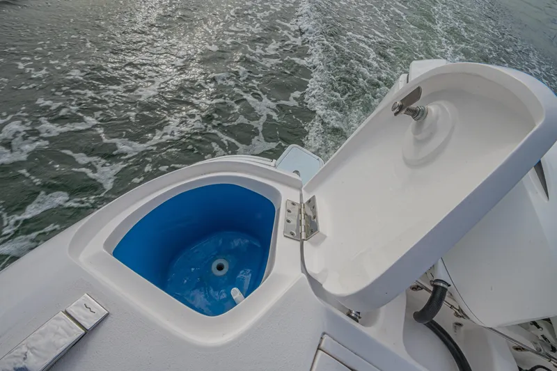 Yacht Photos Pics Open livewell on 2018 Intrepid 407 Cuddy boat, with ocean waves in the background.
