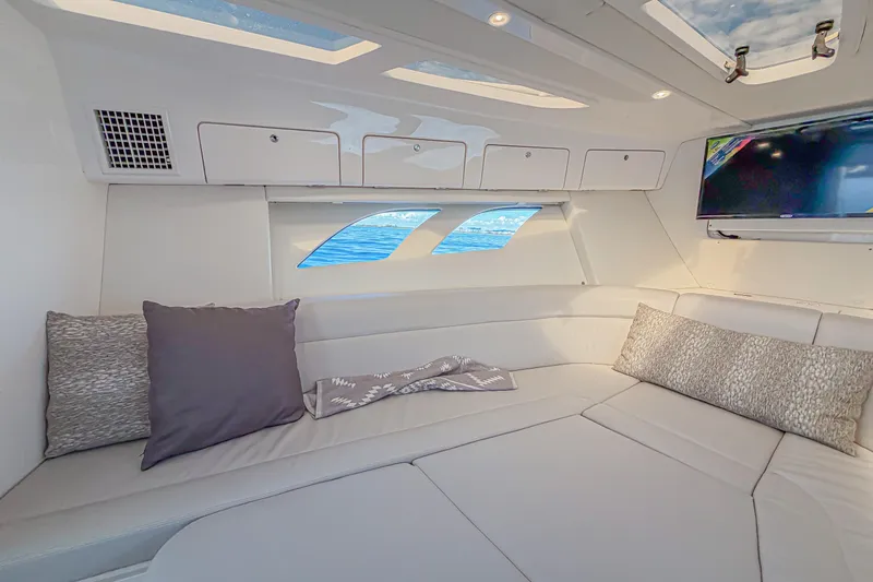  Yacht Photos Pics Luxurious interior of 2018 Intrepid 407 Cuddy boat with plush seating and skylights.