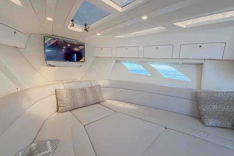  Yacht Photos Pics Luxurious interior of 2018 Intrepid 407 Cuddy with plush seating and mounted TV.