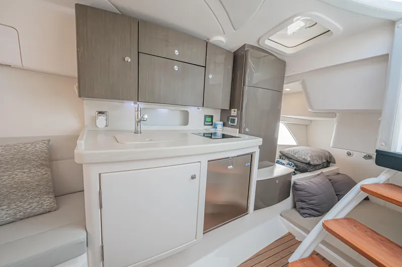  Yacht Photos Pics 2018 Intrepid 407 Cuddy interior with modern kitchen and cozy sleeping area.