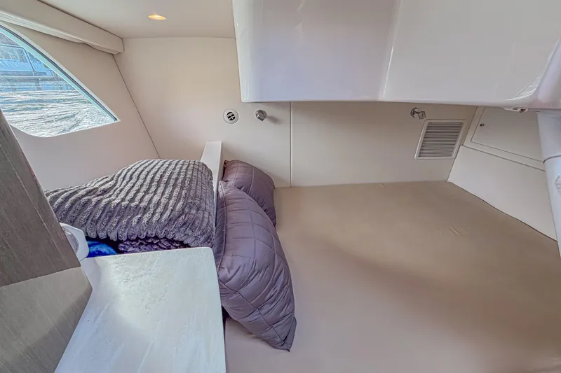  Yacht Photos Pics 2018 Intrepid 407 Cuddy cabin interior with cozy bedding and modern design.
