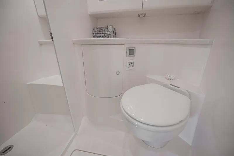  Yacht Photos Pics 2018 Intrepid 407 Cuddy bathroom with modern white fixtures and compact design.