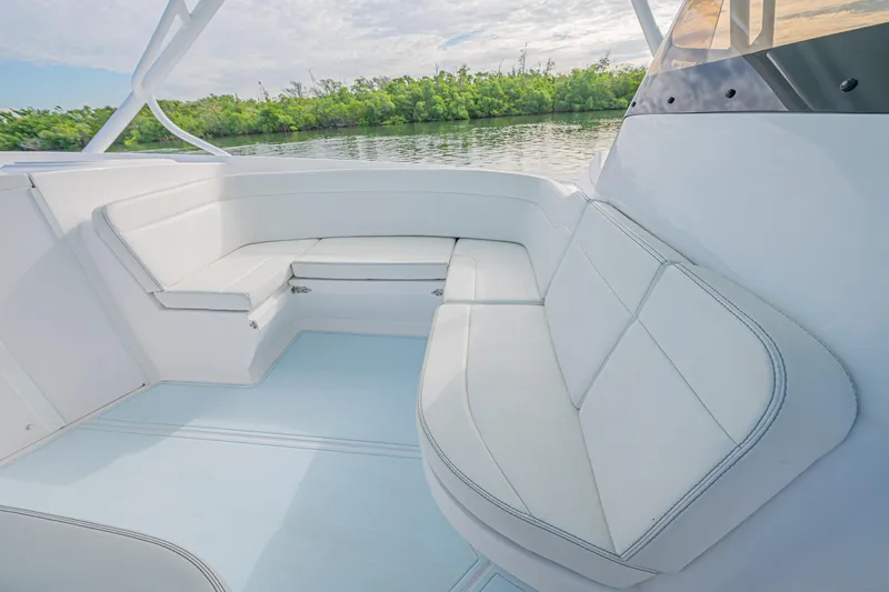  Yacht Photos Pics 2018 Intrepid 407 Cuddy boat interior with white seating and scenic water view.