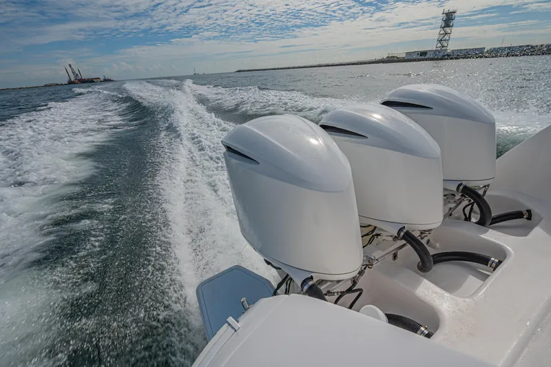  Yacht Photos Pics 2018 Intrepid 407 Cuddy boat with triple outboard engines cruising on open water.
