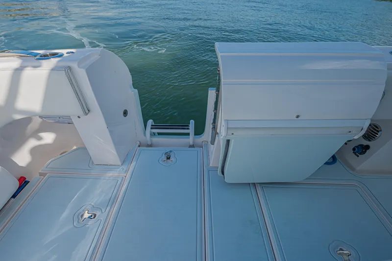  Yacht Photos Pics 2018 Intrepid 407 Cuddy boat deck with open hatch, near calm water.