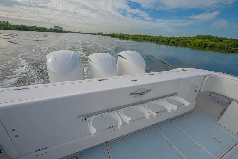  Yacht Photos Pics 2018 Intrepid 407 Cuddy boat cruising on a scenic river with triple engines.