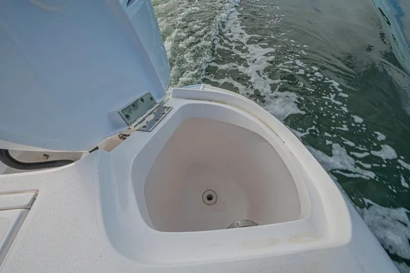  Yacht Photos Pics Open storage compartment on 2018 Intrepid 407 Cuddy boat, with ocean water in background.