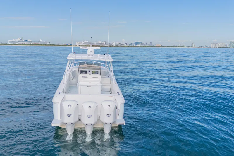  Yacht Photos Pics 2018 Intrepid 407 Cuddy boat on calm ocean with city skyline in background.