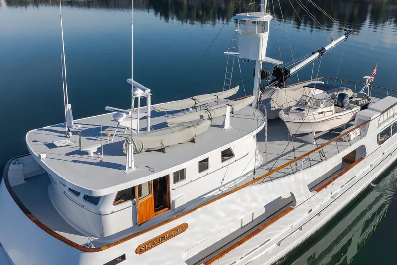 Silverado Yacht Photos Pics Vintage 1974 Willard 1201 yacht, "Silverado," docked on calm water.