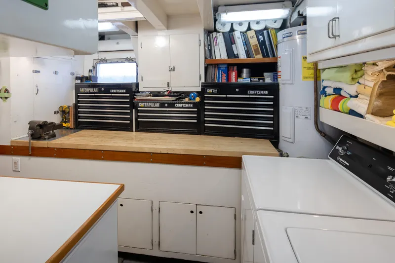 Silverado Yacht Photos Pics Workshop with toolboxes, workbench, and laundry area in a 1974 Willard 1201 model.