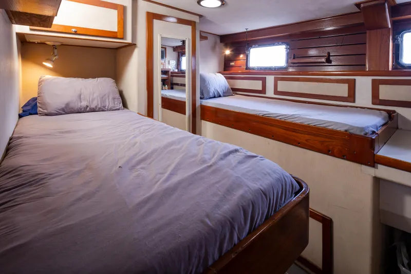 Silverado Yacht Photos Pics Cozy cabin interior of 1974 Willard 1201 with twin beds and wooden accents.