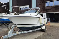 2000 Bayliner 2052 Trophy Walkaround DX/LX on trailer outside a workshop.