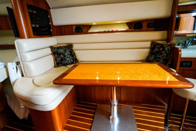 Sommertime Yacht Photos Pics Luxurious interior of 2005 Tiara Yachts 3800 Open with elegant seating and wooden table.