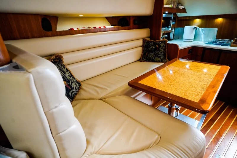 Sommertime Yacht Photos Pics Luxurious interior of 2005 Tiara Yachts 3800 Open with leather seating and wooden table.