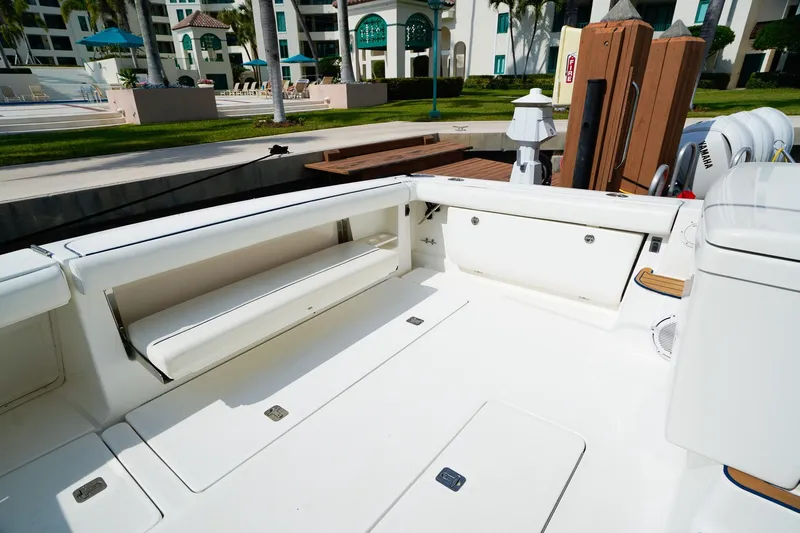 Sommertime Yacht Photos Pics 2005 Tiara Yachts 3800 Open boat deck with seating and storage, docked near a resort.
