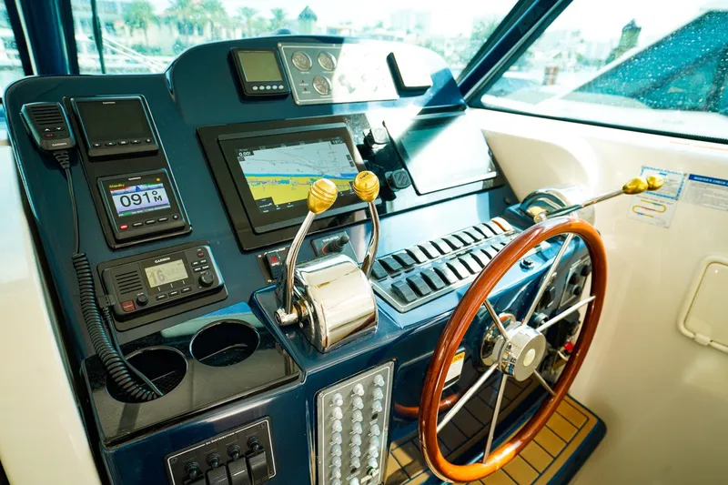 Sommertime Yacht Photos Pics Helm of 2005 Tiara Yachts 3800 Open with navigation equipment and wooden steering wheel.