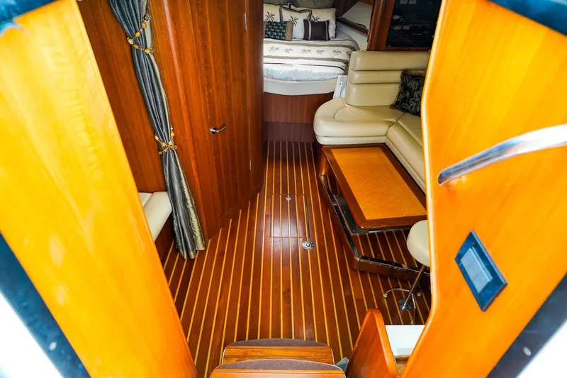 Sommertime Yacht Photos Pics Luxurious interior of 2005 Tiara Yachts 3800 Open with wood flooring and cozy seating.