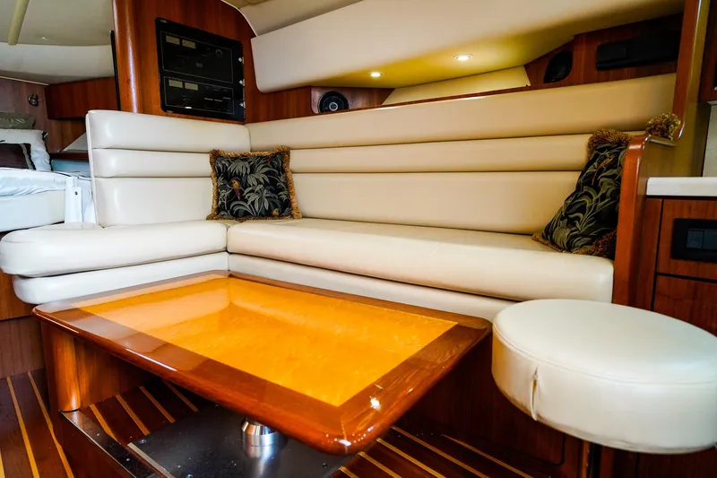 Sommertime Yacht Photos Pics Luxurious interior of 2005 Tiara Yachts 3800 Open with leather seating and wooden table.